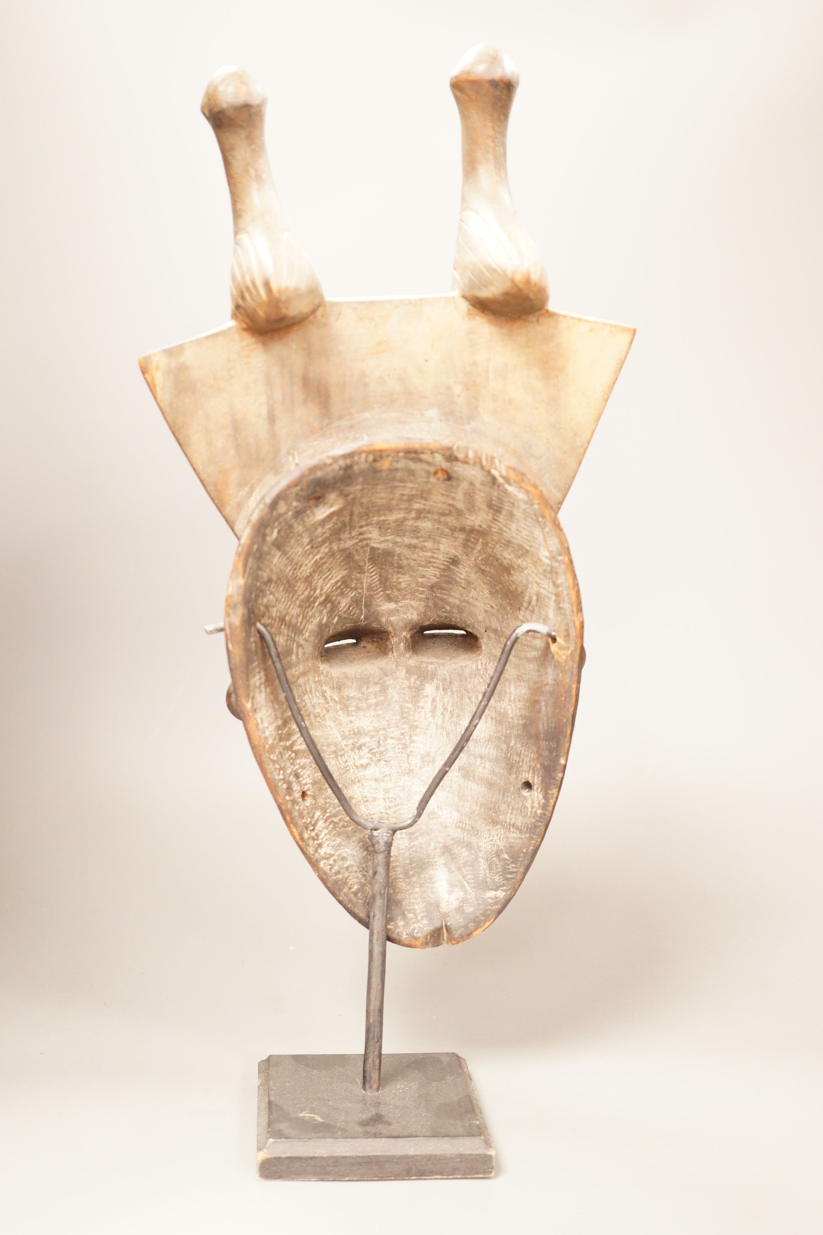 A West African tribal mask, possibly Baule, on stand, 47cm total